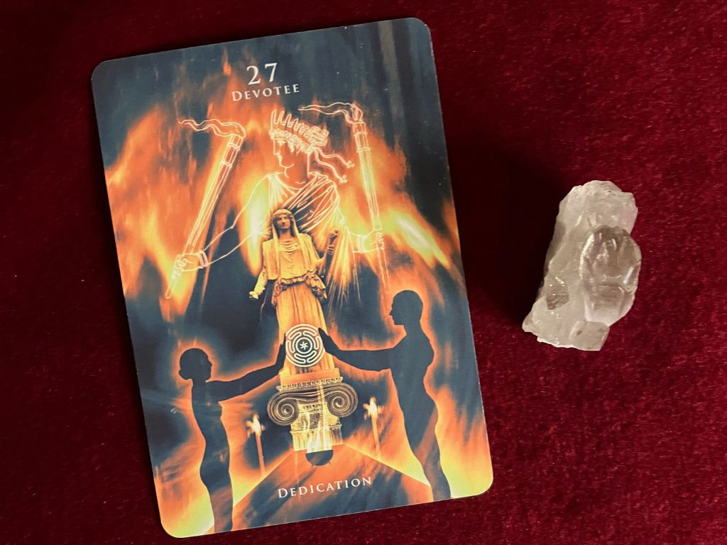 The Devotee – Dedication card from the Hekate Oracle, drawn for morning prayer and reflection, resting on deep red velvet beside a smokey quartz crystal.
