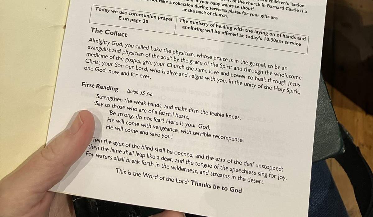 St Luke's Day church service booklet showing the healing ministry announcement and Isaiah 35 Scripture reading.